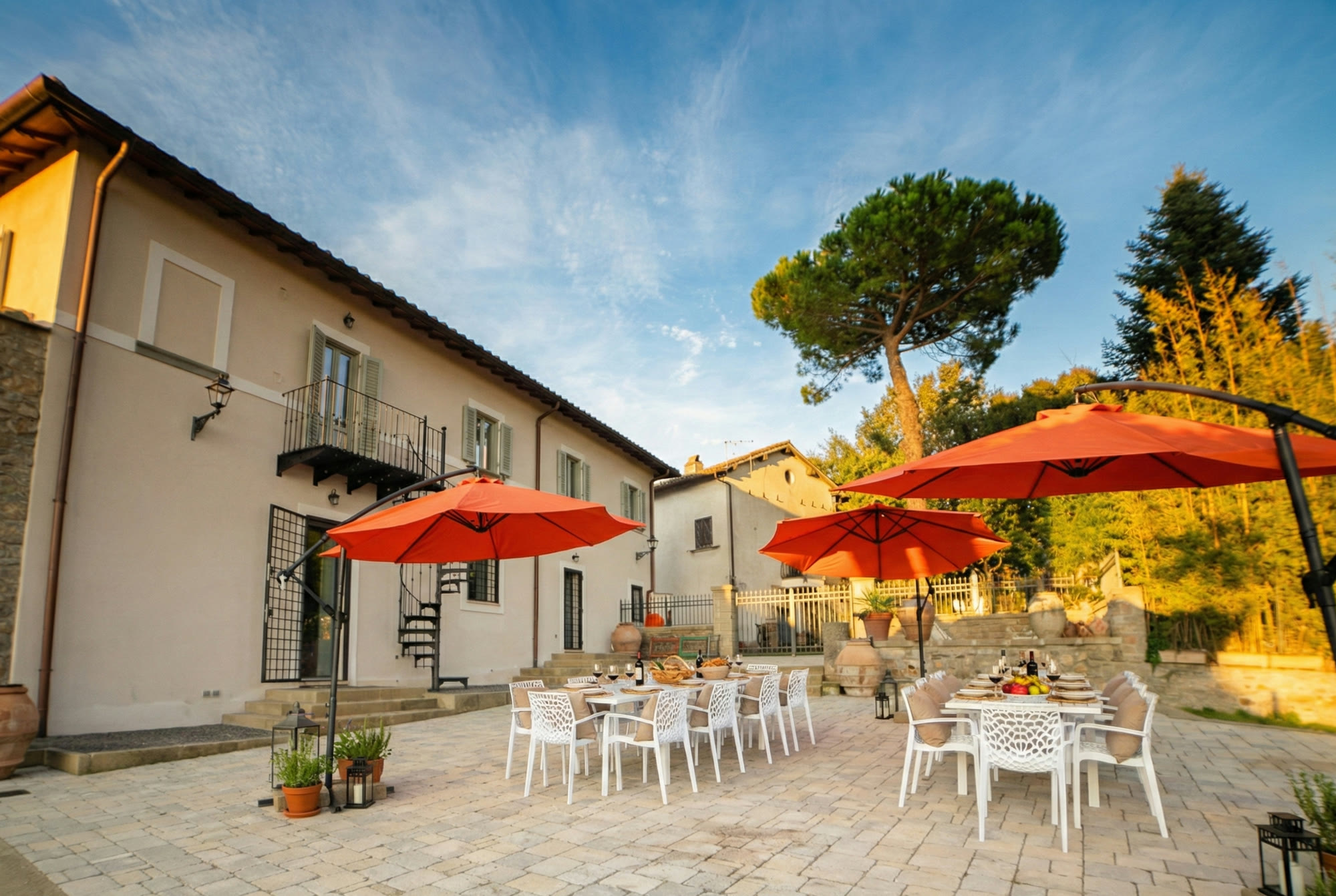 The courtyard tables laid for dinner under umbrellas