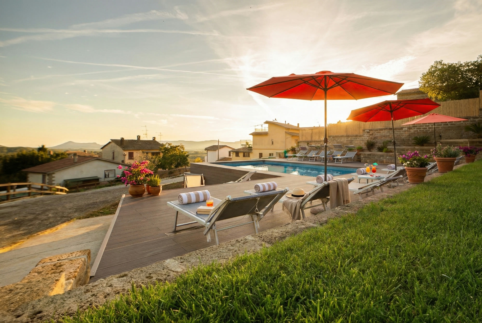 The pool at sunset, looking over rooftops to the Tolfa hills